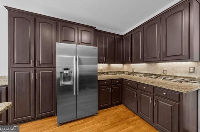 3737 Falls Trl, Winston, GA 30187 - kitchen featuring stainless steel refrigerator with ice dispenser, light wood-type flooring, dark brown cabinets, light stone counters, and tasteful backsplash