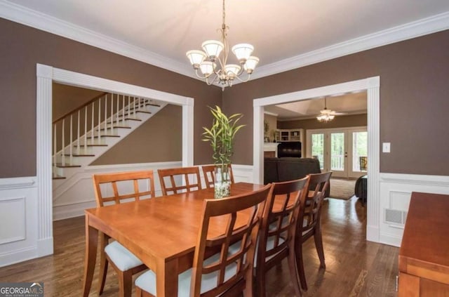 3737 Falls Trl, Winston, GA 30187 - dining space with wood finished floors, crown molding, a decorative wall, stairs, and a chandelier