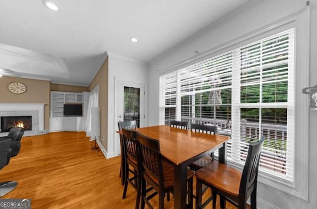 3737 Falls Trl, Winston, GA 30187 - dining space with plenty of natural light, a fireplace, light wood-type flooring, recessed lighting, and ornamental molding