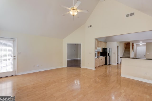 805 River Vly, Dacula, GA 30019 - unfurnished living room with high vaulted ceiling, a ceiling fan, stairway, and light wood finished floors