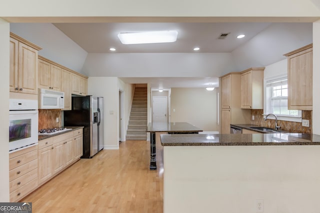 805 River Vly, Dacula, GA 30019 - kitchen featuring white appliances, light brown cabinets, decorative backsplash, a peninsula, and recessed lighting