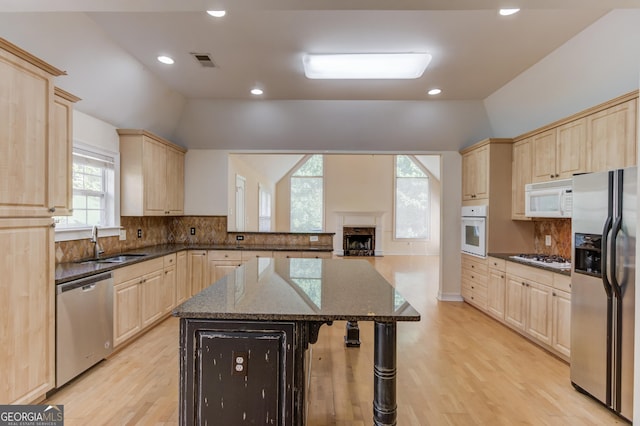 805 River Vly, Dacula, GA 30019 - kitchen with stainless steel appliances, light brown cabinets, vaulted ceiling, light wood-style floors, and recessed lighting