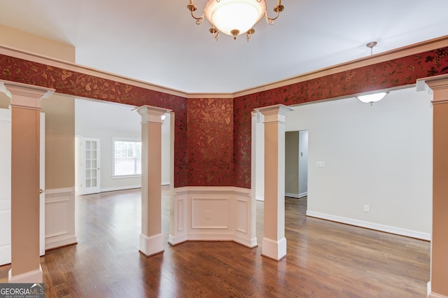 805 River Vly, Dacula, GA 30019 - unfurnished room featuring decorative columns, wallpapered walls, wood finished floors, and wainscoting