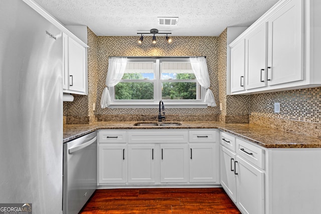 80 Austin Woods Dr, Senoia, GA 30276 - kitchen featuring stainless steel dishwasher, freestanding refrigerator, dark wood finished floors, white cabinets, and tasteful backsplash