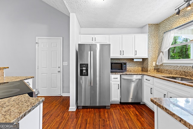 80 Austin Woods Dr, Senoia, GA 30276 - kitchen featuring stainless steel appliances, dark wood finished floors, white cabinetry, a textured ceiling, and light stone counters