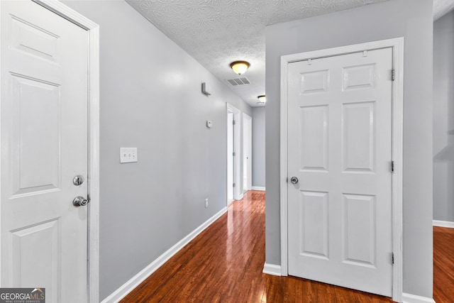 80 Austin Woods Dr, Senoia, GA 30276 - hallway with dark wood-style floors and a textured ceiling