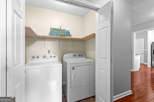 80 Austin Woods Dr, Senoia, GA 30276 - laundry room with washer and clothes dryer, a textured ceiling, and dark wood-type flooring