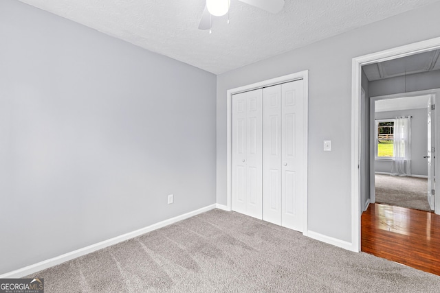 80 Austin Woods Dr, Senoia, GA 30276 - unfurnished bedroom featuring carpet, attic access, a closet, a textured ceiling, and ceiling fan