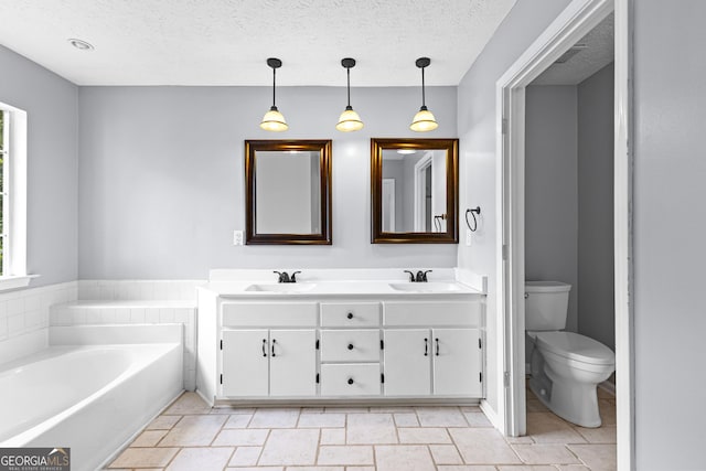 80 Austin Woods Dr, Senoia, GA 30276 - full bathroom with double vanity, a bath, and a textured ceiling