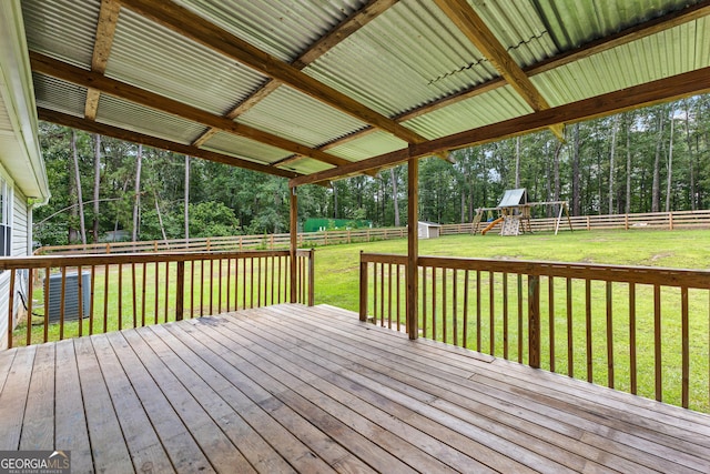 80 Austin Woods Dr, Senoia, GA 30276 - wooden deck with a playground, a fenced backyard, and view of wooded area