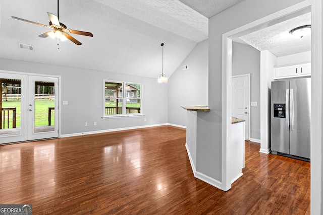 80 Austin Woods Dr, Senoia, GA 30276 - unfurnished living room featuring a textured ceiling, lofted ceiling, a ceiling fan, healthy amount of natural light, and dark wood finished floors