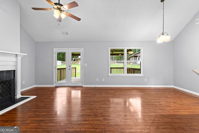 80 Austin Woods Dr, Senoia, GA 30276 - unfurnished living room featuring lofted ceiling, wood finished floors, ceiling fan, a fireplace, and a chandelier