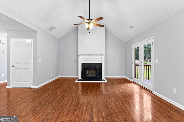 80 Austin Woods Dr, Senoia, GA 30276 - unfurnished living room with wood finished floors, ceiling fan, a tiled fireplace, lofted ceiling, and a textured ceiling