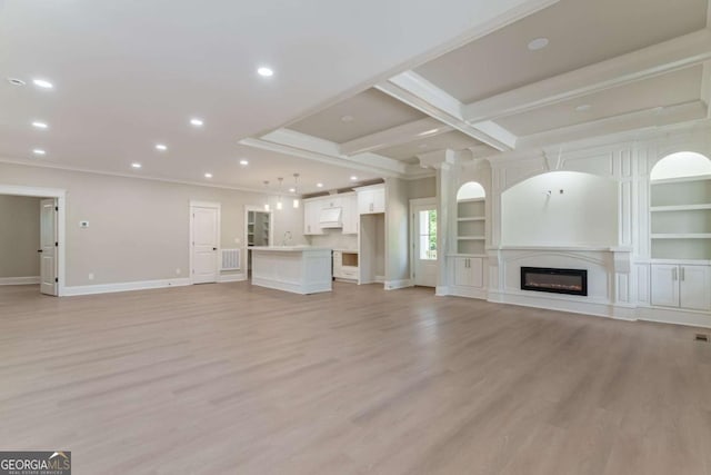 540 Sunset Ave, Comer, GA 30629 - unfurnished living room featuring recessed lighting, light wood finished floors, ornamental molding, a glass covered fireplace, and built in shelves