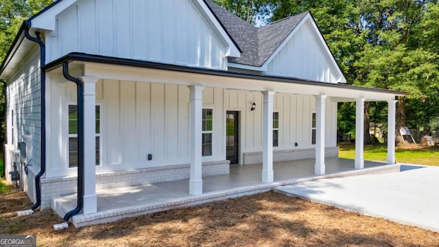 540 Sunset Ave, Comer, GA 30629 - rear view of house with covered porch, a shingled roof, and board and batten siding