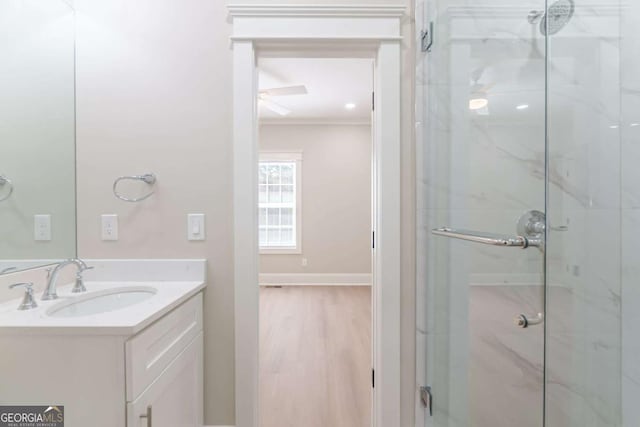 540 Sunset Ave, Comer, GA 30629 - bathroom with a marble finish shower, vanity, ornamental molding, and wood finished floors