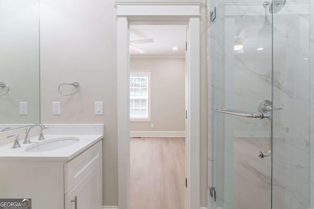 540 Sunset Ave, Comer, GA 30629 - bathroom with a marble finish shower, vanity, wood finished floors, and ornamental molding