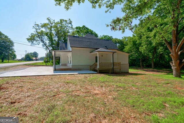 540 Sunset Ave, Comer, GA 30629 - rear view of house with a lawn, a patio, driveway, and roof with shingles