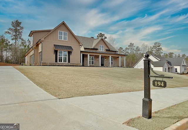 194 Forest Berry Ct Unit 98M2, Newnan, GA 30265 - craftsman house featuring board and batten siding, covered porch, a front lawn, and stone siding