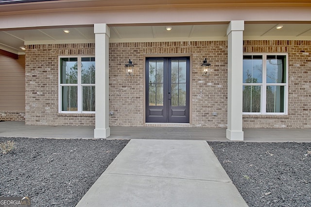194 Forest Berry Ct Unit 98M2, Newnan, GA 30265 - view of exterior entry featuring french doors, brick siding, and covered porch