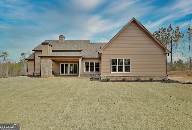 194 Forest Berry Ct Unit 98M2, Newnan, GA 30265 - rear view of house featuring a ceiling fan, a shingled roof, and a chimney