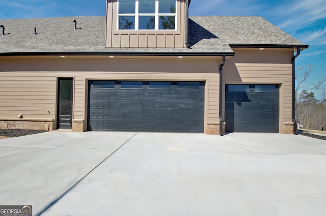 194 Forest Berry Ct Unit 98M2, Newnan, GA 30265 - view of property exterior with concrete driveway, a shingled roof, board and batten siding, and brick siding