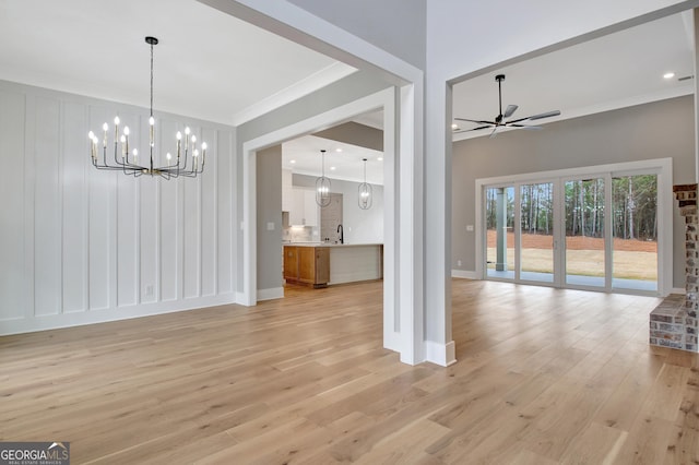 194 Forest Berry Ct Unit 98M2, Newnan, GA 30265 - unfurnished dining area with a chandelier, a ceiling fan, light wood-style floors, and ornamental molding