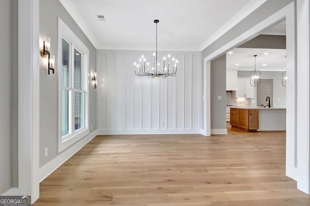 194 Forest Berry Ct Unit 98M2, Newnan, GA 30265 - unfurnished dining area featuring a chandelier, ornamental molding, light wood-type flooring, and recessed lighting