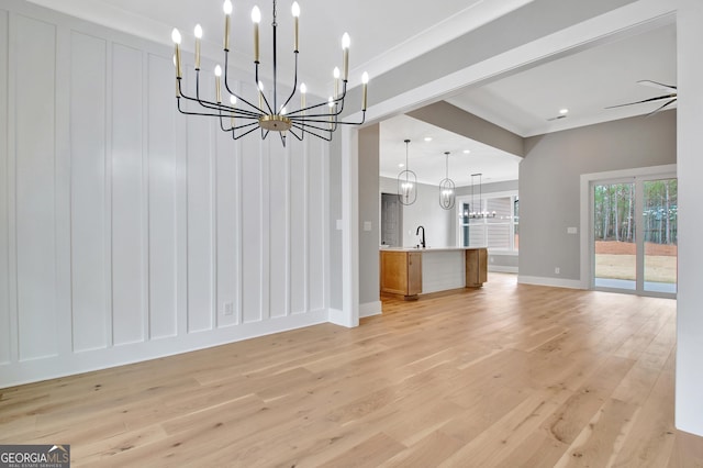 194 Forest Berry Ct Unit 98M2, Newnan, GA 30265 - unfurnished living room featuring a chandelier, light wood-style flooring, and a decorative wall