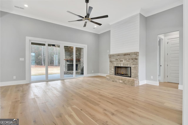 194 Forest Berry Ct Unit 98M2, Newnan, GA 30265 - unfurnished living room featuring a ceiling fan, a brick fireplace, light wood-style flooring, recessed lighting, and crown molding