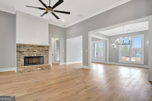 194 Forest Berry Ct Unit 98M2, Newnan, GA 30265 - unfurnished living room featuring ornamental molding, light wood-type flooring, a ceiling fan, a chandelier, and a fireplace