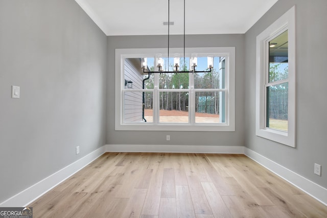 194 Forest Berry Ct Unit 98M2, Newnan, GA 30265 - unfurnished dining area with light wood-type flooring, a chandelier, and ornamental molding