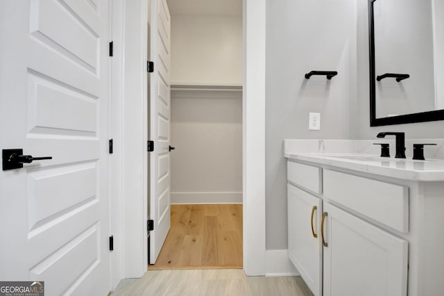 194 Forest Berry Ct Unit 98M2, Newnan, GA 30265 - bathroom with vanity, a closet, and wood finished floors