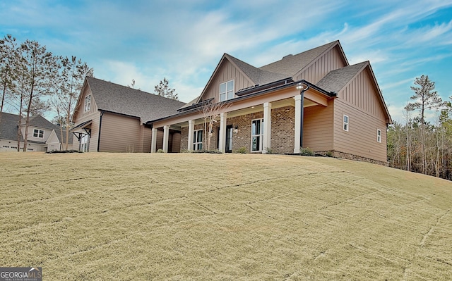 194 Forest Berry Ct Unit 98M2, Newnan, GA 30265 - craftsman inspired home with board and batten siding, a porch, a front yard, and roof with shingles
