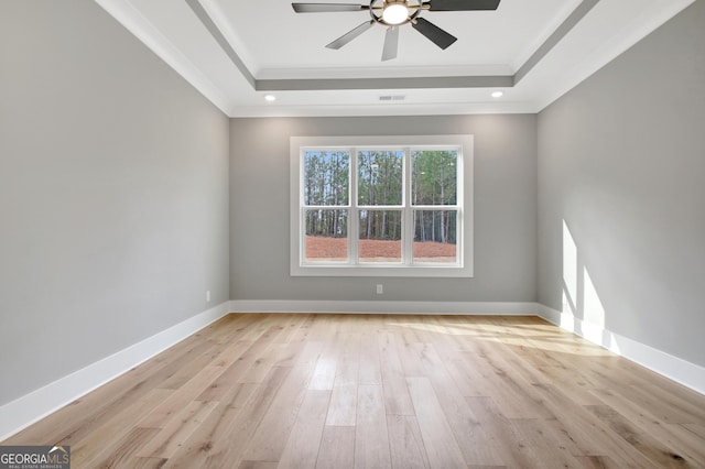 194 Forest Berry Ct Unit 98M2, Newnan, GA 30265 - empty room featuring a raised ceiling, light wood-style flooring, crown molding, and a ceiling fan