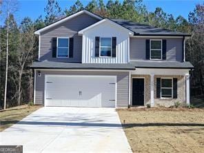 15 Barton Ln, Covington, GA 30016 - traditional-style house with driveway, an attached garage, and covered porch