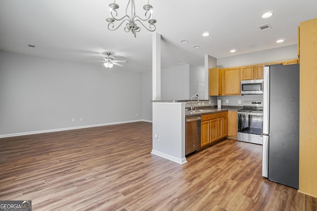 2203 Hyssop Way, Buford, GA 30519 - kitchen with appliances with stainless steel finishes, wood finished floors, a ceiling fan, recessed lighting, and open floor plan