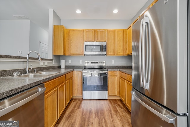 2203 Hyssop Way, Buford, GA 30519 - kitchen featuring stainless steel appliances, dark countertops, light wood-style floors, and recessed lighting