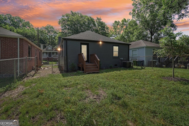 524 Paines Ave NW, Atlanta, GA 30318 - back of house with a fenced backyard, brick siding, and roof with shingles