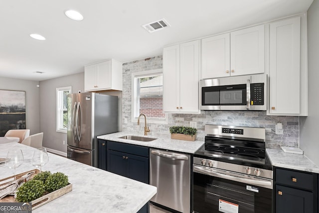 524 Paines Ave NW, Atlanta, GA 30318 - kitchen featuring appliances with stainless steel finishes, white cabinets, healthy amount of natural light, and recessed lighting