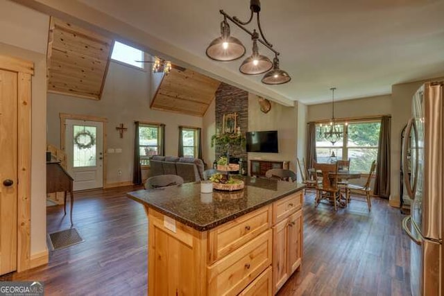 87 Harbin Ct, Morganton, GA 30560 - kitchen with freestanding refrigerator, dark wood finished floors, a kitchen island, decorative light fixtures, and dark stone countertops