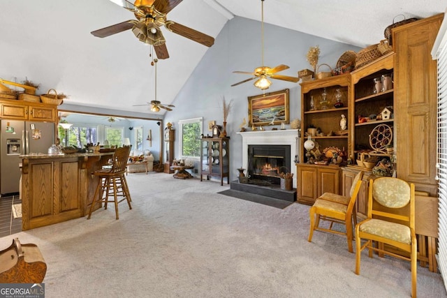 1320 Tal Lewis Rd, White Plains, GA 30678 - living room with high vaulted ceiling, ceiling fan, light colored carpet, and a glass covered fireplace
