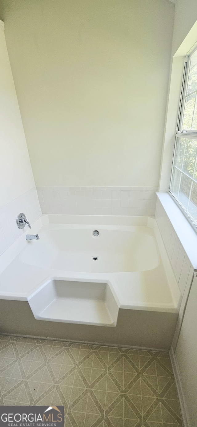 116 Ventura Trl, Stockbridge, GA 30281 - full bathroom featuring a garden tub and tile patterned floors