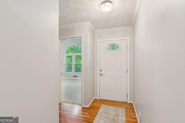 120 Timbervalley Ln, Lawrenceville, GA 30043 - entryway with light wood finished floors, ornamental molding, and a textured ceiling