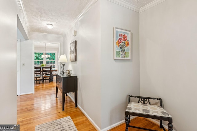 120 Timbervalley Ln, Lawrenceville, GA 30043 - hall with light wood-type flooring, a textured ceiling, ornamental molding, and a chandelier