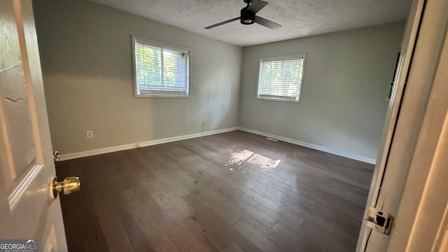 4550 Cypress Ridge Ct, Stone Mountain, GA 30083 - unfurnished bedroom with multiple windows, a textured ceiling, dark wood-type flooring, and a ceiling fan