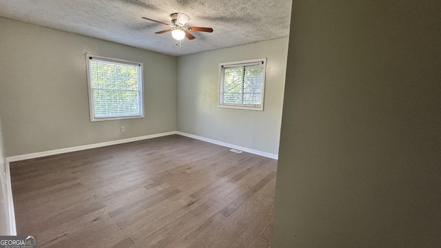 4550 Cypress Ridge Ct, Stone Mountain, GA 30083 - unfurnished room featuring ceiling fan, dark wood finished floors, and a textured ceiling