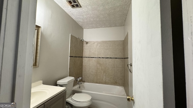 4550 Cypress Ridge Ct, Stone Mountain, GA 30083 - full bathroom featuring a textured ceiling, vanity, and tub / shower combination