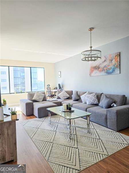 3481 Lakeside Unit 2204, Atlanta, GA 30326 - living room featuring a chandelier and wood finished floors