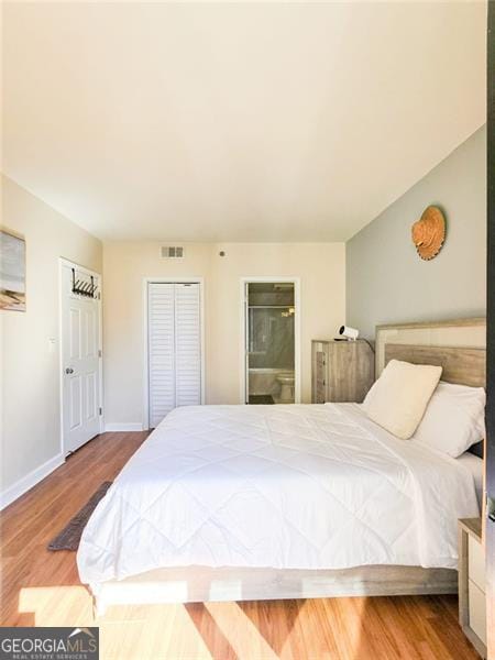 3481 Lakeside Unit 2204, Atlanta, GA 30326 - bedroom featuring wood finished floors and ensuite bath